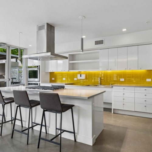 Modern shared kitchen area with countertop space and bar stools