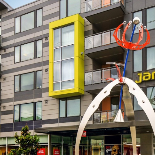Janus Apartments exterior building with bold structure and city backdrop in Seattle
